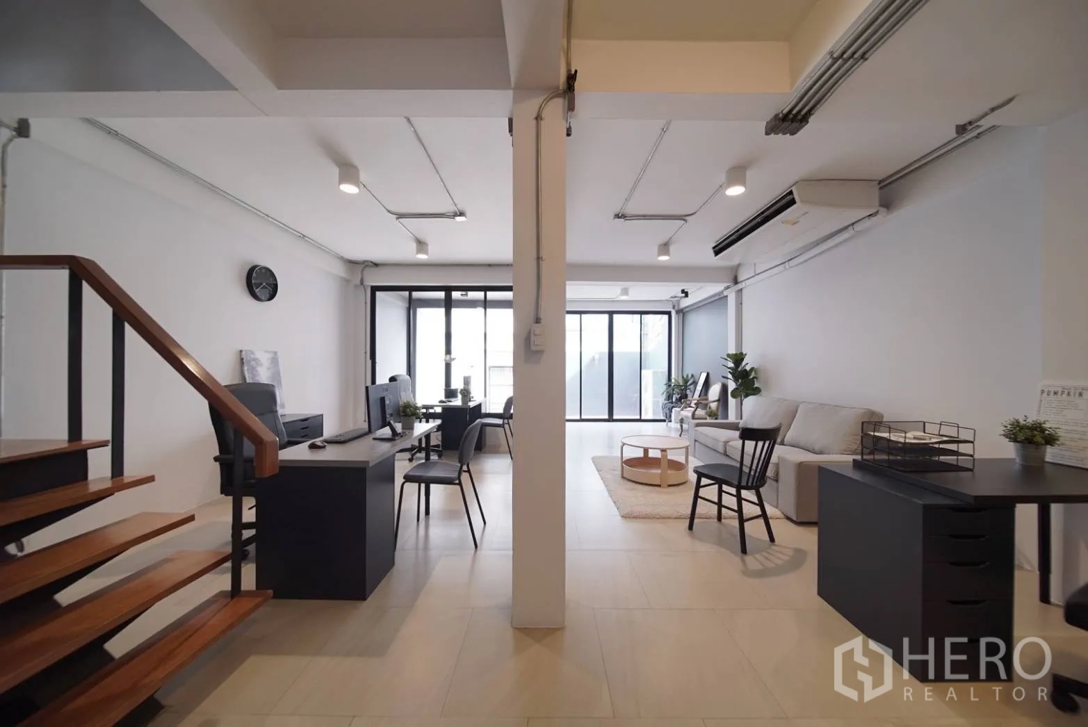 ทาวน์เฮาส์ ให้เช่าในWatthana, Bangkok - มุมมองชั้นล่างไปยังประตูกระจก มีโต๊ะทำงานและมุมนั่งเล่น