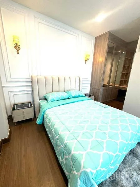 Detached House for rent in Bang Phli, Samut Prakan - Cozy bedroom with teal bedding, paneled wall and walk‑in closet entry