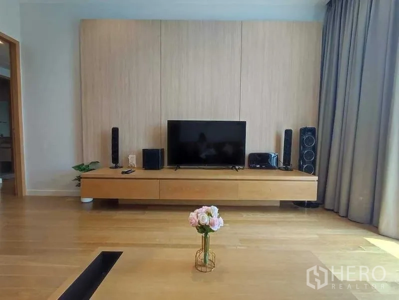 คอนโด ให้เช่าในKhlong Toei, Bangkok - ห้องนั่งเล่นสไตล์โมเดิร์น ชุดทีวีบิวท์อิน พื้นไม้ ผ้าม่านสูง และโต๊ะกลางดอกไม้