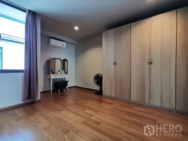 ทาวน์เฮาส์ ขาย - ห้องนอนพร้อมตู้เสื้อผ้าบิวท์อินเต็มผนัง โต๊ะเครื่องแป้ง และพื้นไม้