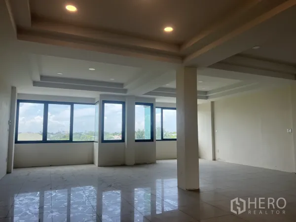 Home Office for rent in Suan Luang, Bangkok - Bright open-plan floor with large corner windows, recessed ceiling lights and glossy tiled flooring with city views.