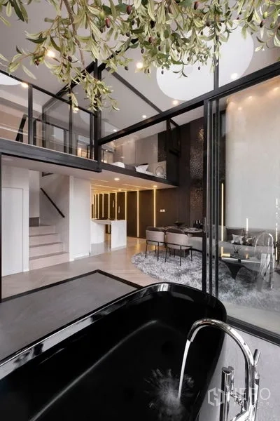 Detached House for sale in Watthana, Bangkok - Black soaking tub with running water facing a loft-style dining area and mezzanine bedroom.