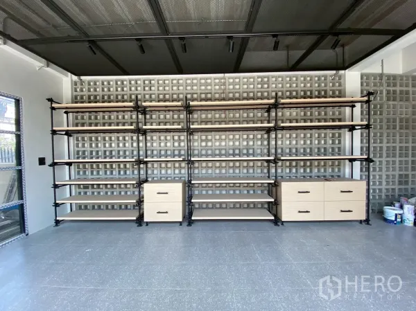 Detached House for sale in Mueang Nakhon Pathom, Nakhon Pathom - Room with industrial built-in shelving against a decorative breeze-block wall and polished flooring.