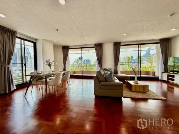 Condominium for rent - Corner living space with dining set and multiple sliding doors opening to a wraparound balcony.