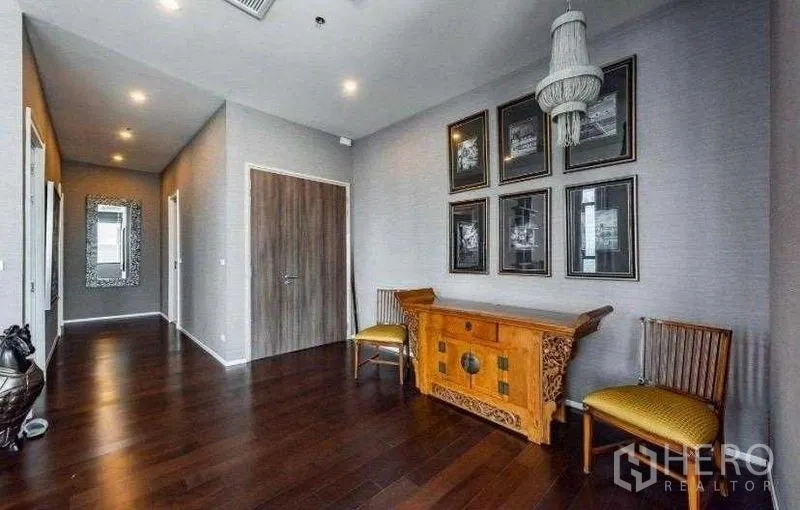 Condominium for rent - Elegant hallway featuring a wooden console, framed artwork and rich hardwood flooring.