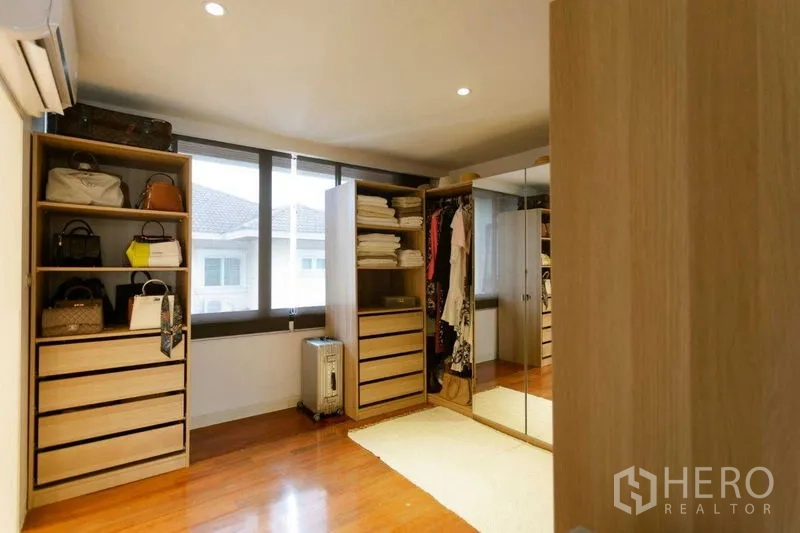 Home Office for sale in Watthana, Bangkok - Walk-in closet featuring open wardrobes, drawers and a full-height mirrored cabinet.