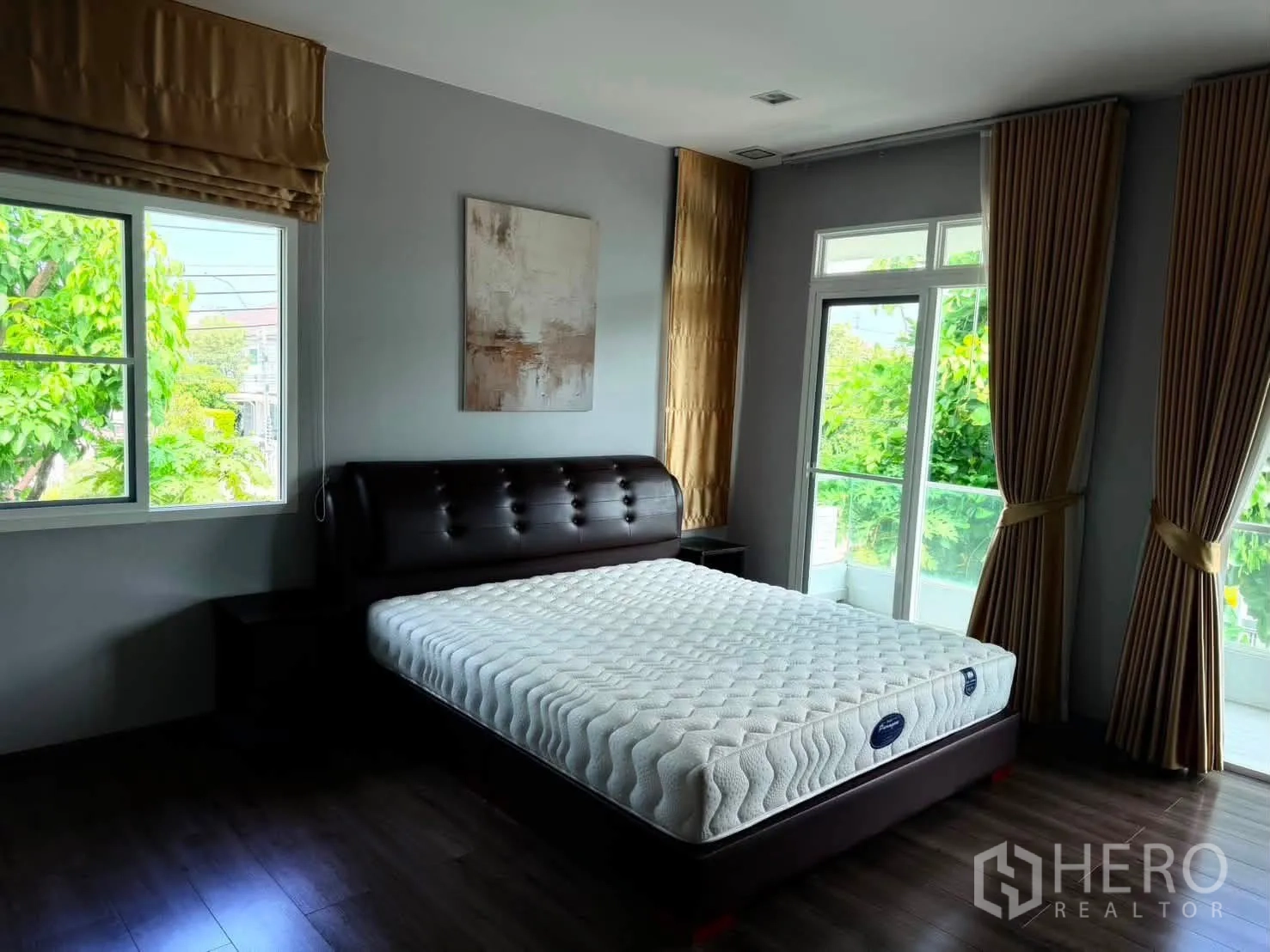Detached House for rent in Bang Phli, Samut Prakan - Bedroom with big windows, curtains, and upholstered bedframe.