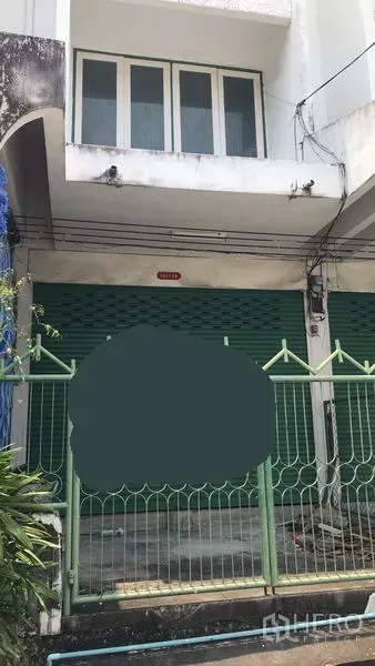 Home Office for rent in Watthana, Bangkok - Shophouse-style home office exterior with green roller shutters, gated entry, and upper-floor windows in Watthana, Bangkok.