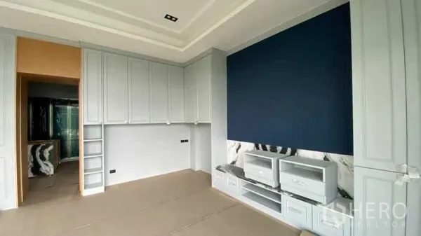บ้าน ขายในMueang Nonthaburi, Nonthaburi - ห้องนอนตู้เสื้อผ้าบิลท์อินเต็มผนัง ผนังตกแต่งสีน้ำเงิน และมุมทีวีบิลท์อิน