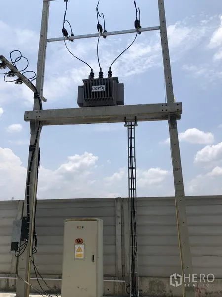 Factory for rent or sale in Lat Lum Kaeo, Pathum Thani - On-site electrical transformer and control cabinet installed by the perimeter fence.