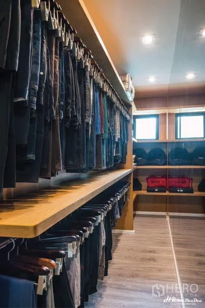 Townhouse for sale in Lak Si, Bangkok - Spacious walk-in closet with double hanging rails and wood shelving.