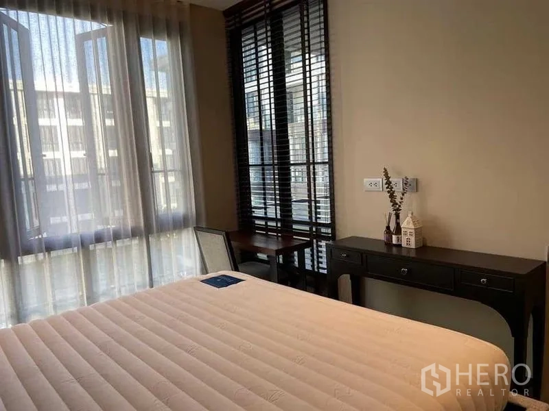 Condominium for rent or sale - Bright bedroom with large windows, desk and sheer curtains