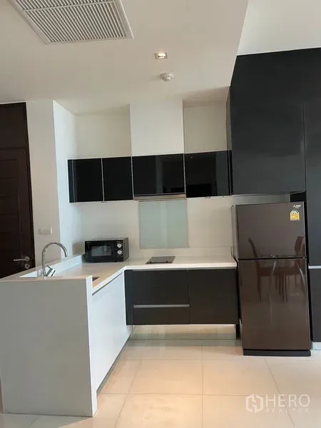 คอนโด ให้เช่าในWatthana, Bangkok - ครัวแบบเปิดสไตล์โมเดิร์น ตู้สีดำ ท็อปสีขาว อ่างล้าง และตู้เย็นขนาดใหญ่