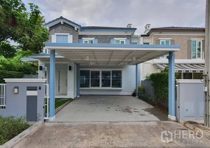 Detached House for rent - Two-storey detached house at Anya Bangna–Ramkhamhaeng 2 with covered two-car carport and front yard.