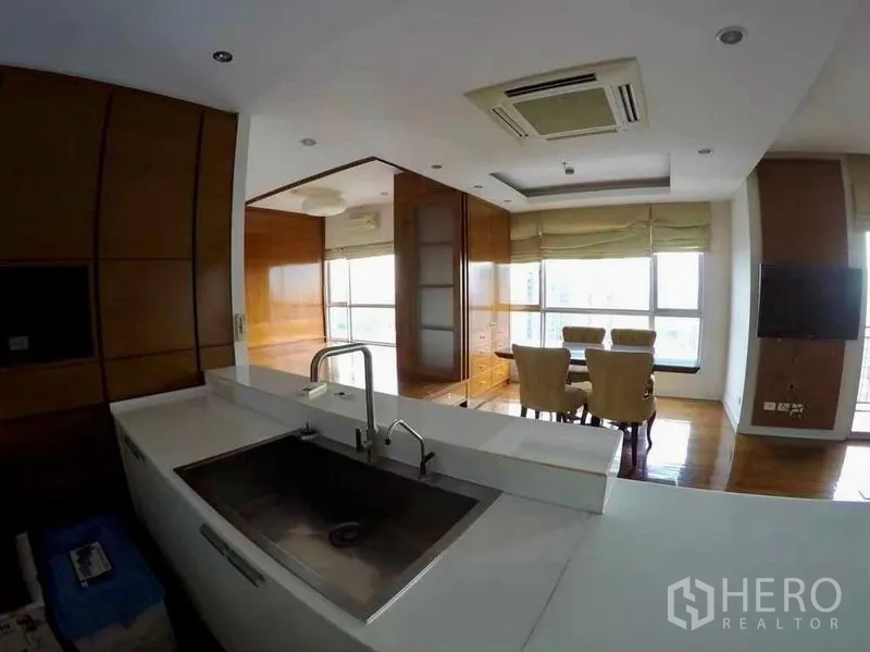 Condominium for rent or sale in Khlong San, Bangkok - Kitchen sink outlook toward dining space and panoramic windows.