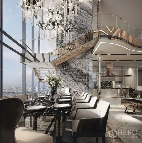 Condominium for sale in Bangkok - Opulent dining room with marble feature wall, grand chandelier and sculptural staircase.
