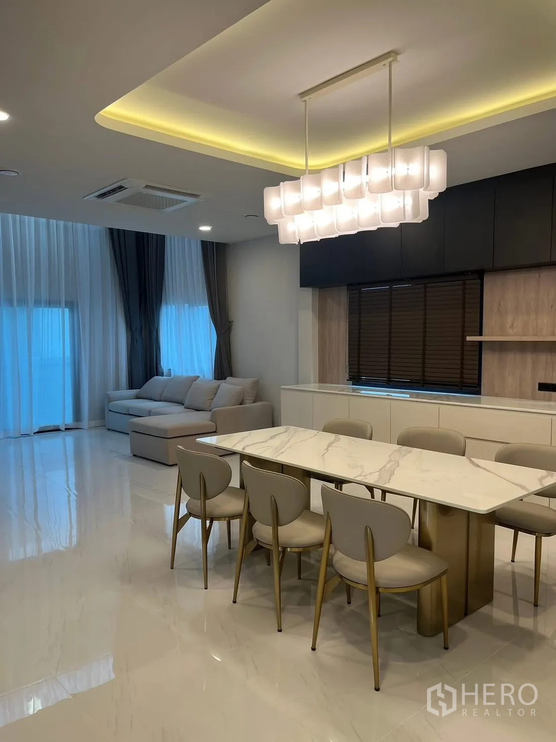 Detached House for rent in Bang Phli, Samut Prakan - Open-plan dining and living area with marble-top table and sofa.