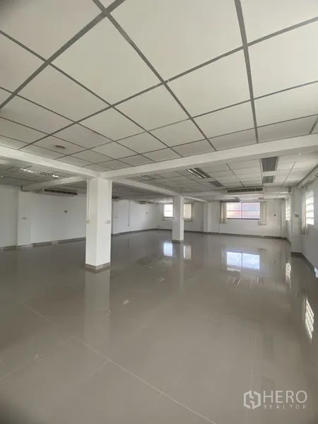 Office Space for rent in Khlong Toei, Bangkok - Spacious empty office floor with polished tiles, multiple windows and wall-mounted air-conditioning units.