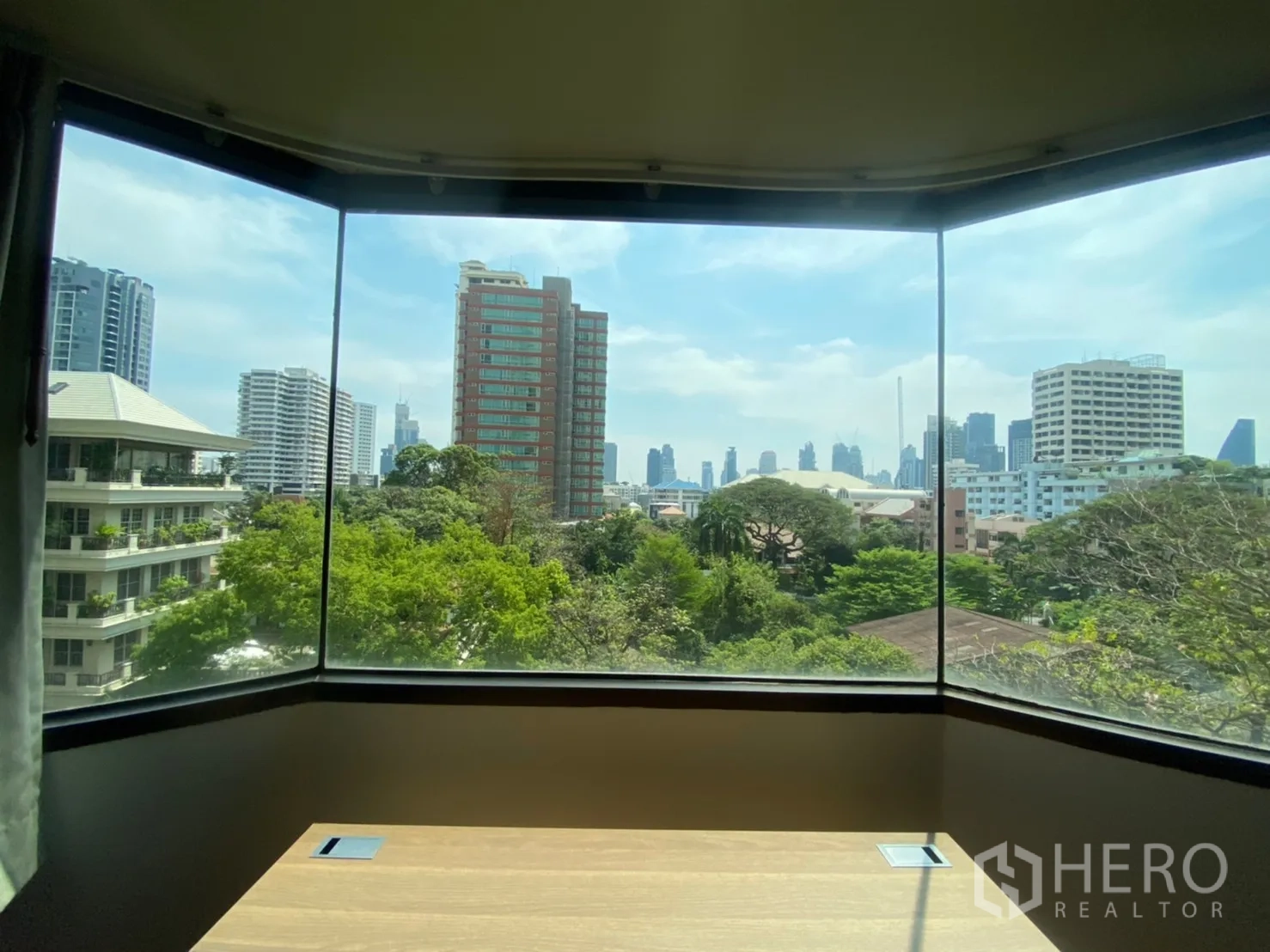 Condominium for rent in Watthana, Bangkok - Bay window with panoramic city skyline and treetop views in the Sukhumvit area.