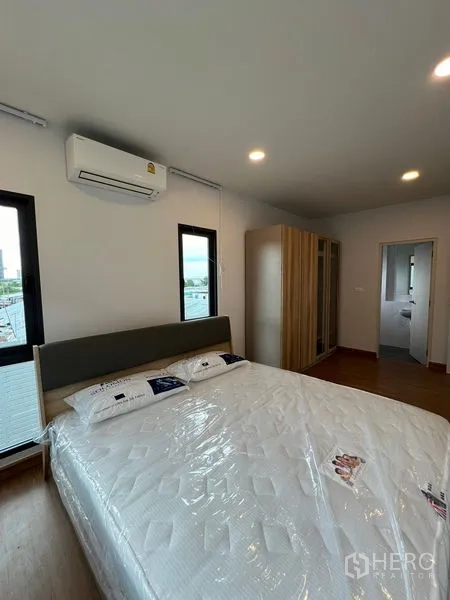 Detached House for rent or sale in Bang Phli, Samut Prakan - Guest bedroom angle showing en-suite entrance and wardrobe.