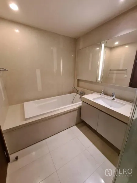 Condominium for rent in Watthana, Bangkok - Modern bathroom featuring a built‑in bathtub, wide vanity and soft lighting.