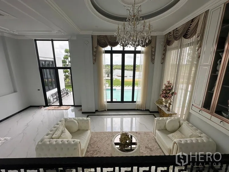Detached House for sale in Sai Noi, Nonthaburi - Living room outlook to pool and lakeside garden from the upper landing.