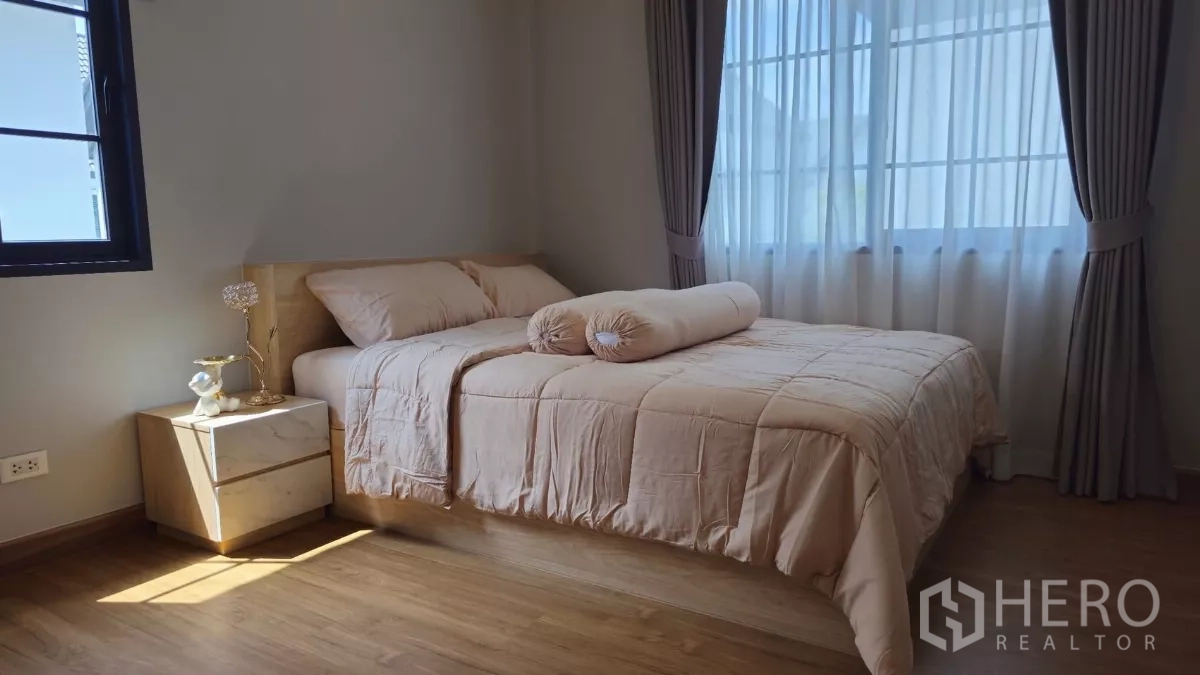 Detached House for rent or sale in Bang Phli, Samut Prakan - Guest bedroom corner with natural light through windows and soft drapery.