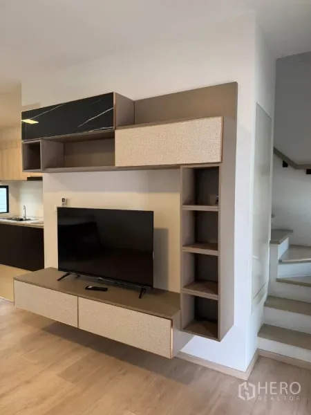 Townhouse for rent in Bang Phli, Samut Prakan - Close-up of modern floating TV cabinet with shelves beside the staircase.