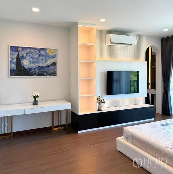 Detached House for rent or sale in Bang Phli, Samut Prakan - Bedroom with built-in TV wall, illuminated shelving, desk, and air conditioning.