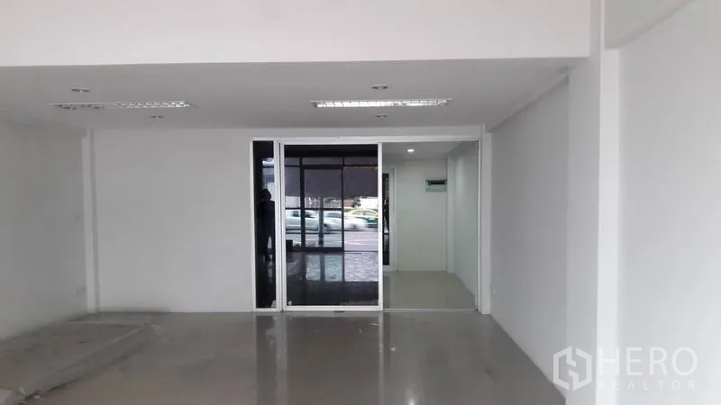 Office Space for rent in Bueng Kum, Bangkok - Open-plan ground floor office with sliding glass doors facing street parking.