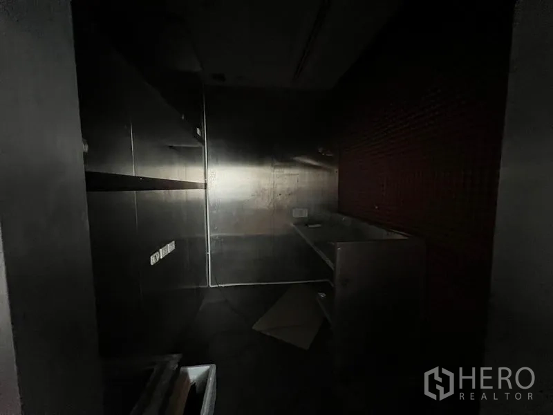 零售空间 出租 - 光线昏暗的储物/备餐间，设不锈钢墙板与水槽