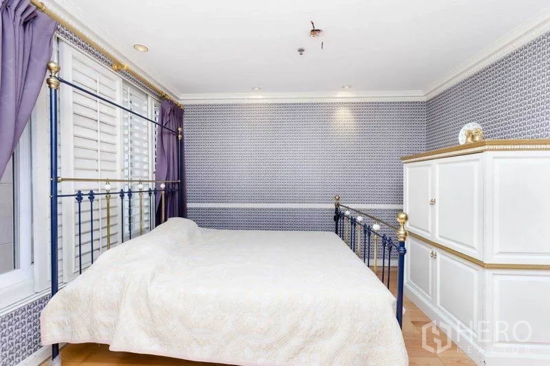 Condominium for rent or sale in Pathum Wan, Bangkok - Bright bedroom with metal frame bed, shuttered windows, and white built-in cabinets.