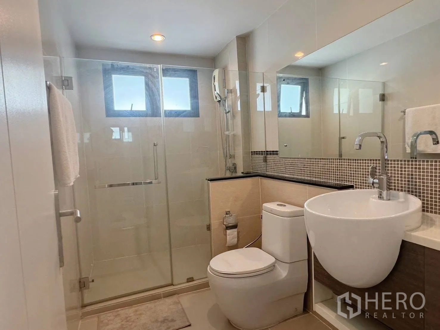 Detached House for rent or sale in Suan Luang, Bangkok - Bathroom with large mirror, vanity and clear glass shower.