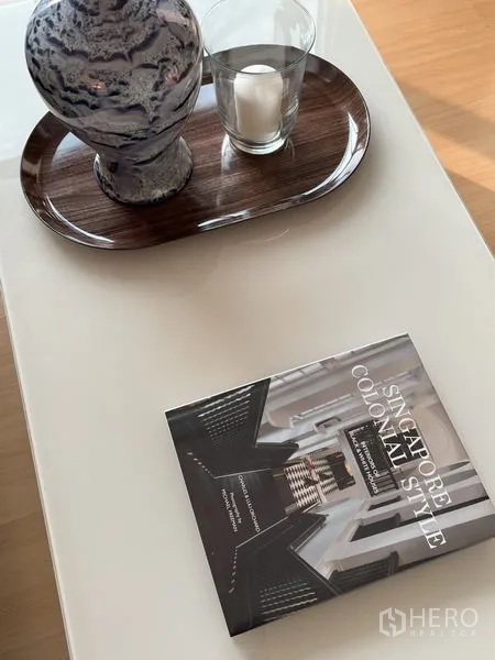 Condominium for rent or sale - Close-up of coffee table decor with tray, candle and design book.