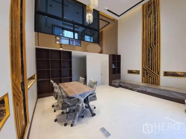 Home Office for rent in Bueng Kum, Bangkok - Open meeting room with tall decorative walls, wood shelving, floor outlets, and a glass mezzanine.