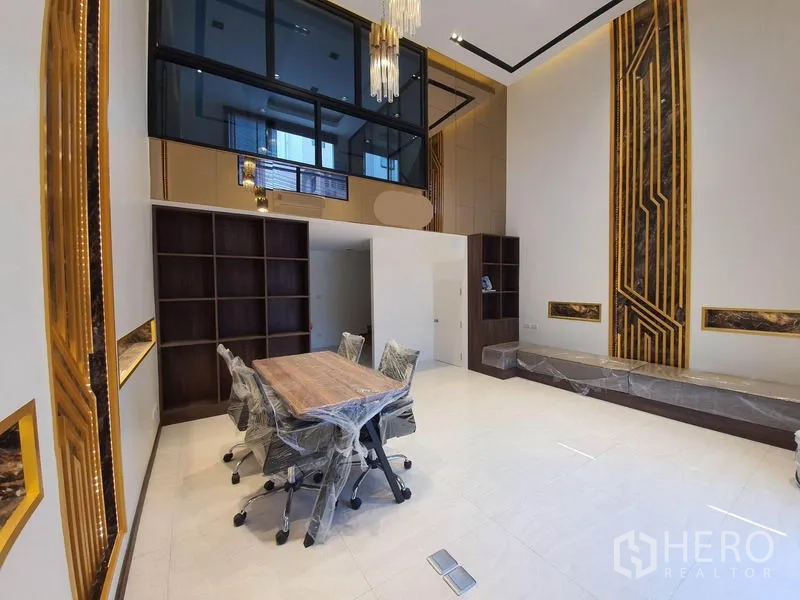 Home Office for rent in Bueng Kum, Bangkok - Open meeting room with tall decorative walls, wood shelving, floor outlets, and a glass mezzanine.