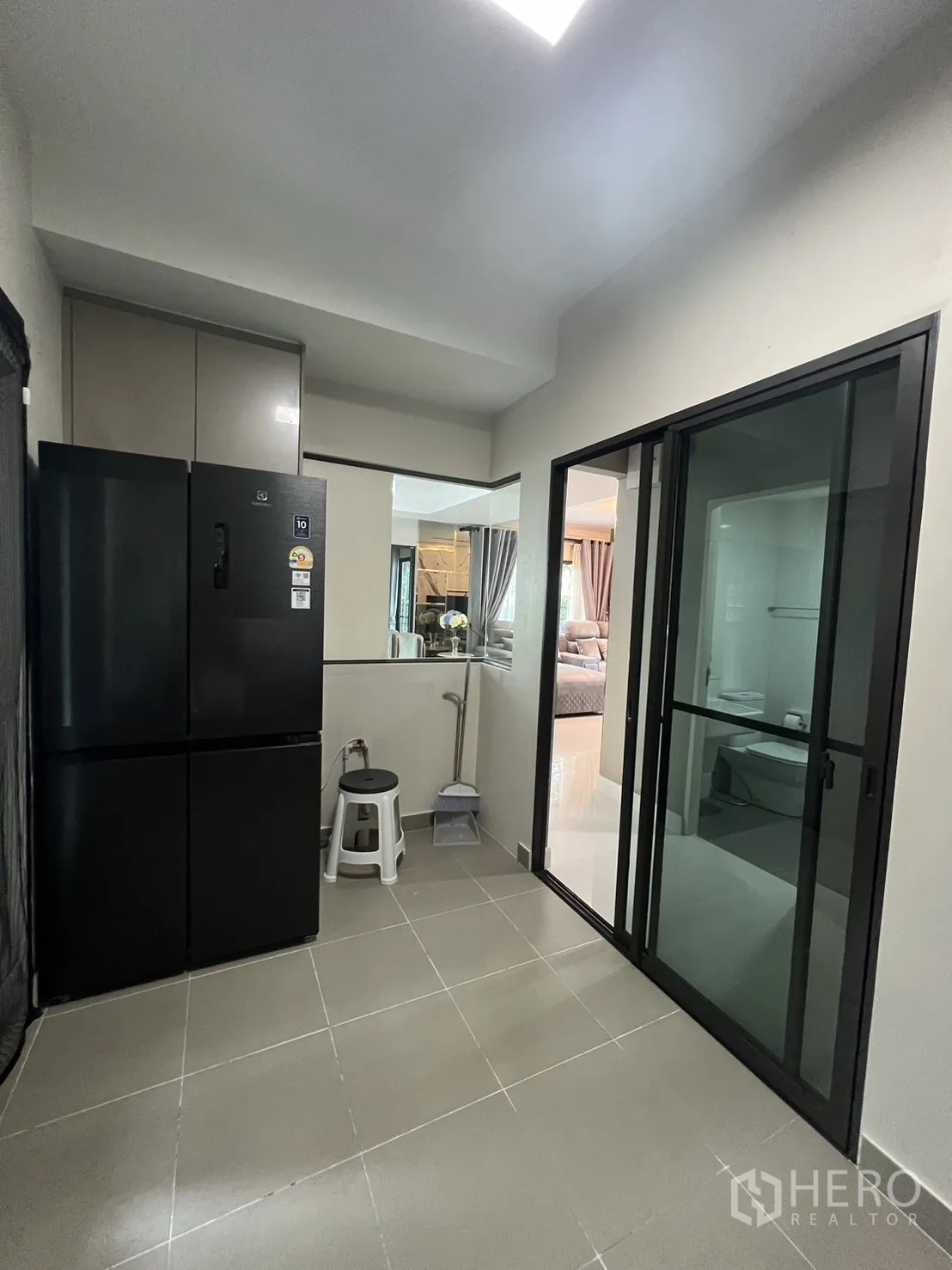 Detached House for rent in Bang Phli, Samut Prakan - Pantry area with tall refrigerator, storage cabinets and glass doors.