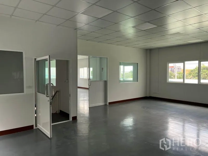 Warehouse for rent in Lat Krabang, Bangkok - Open-plan office level with glass partitions, stair access and natural light