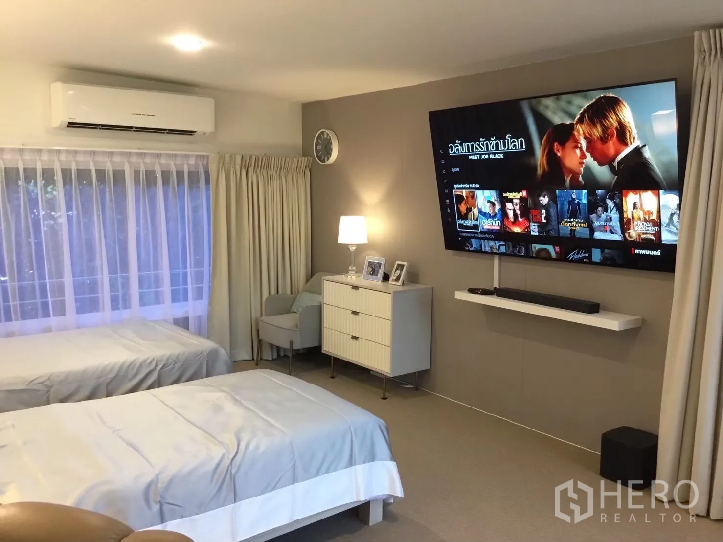 บ้านเดี่ยว for sale in Suan Luang, Bangkok - ห้องนอนเตียงคู่พร้อมทีวีติดผนังขนาดใหญ่และไฟสลัว