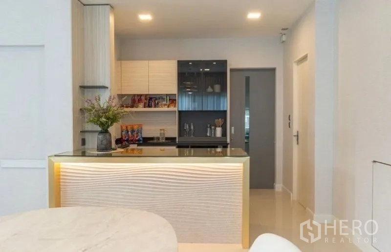 Detached House for rent in Bang Phli, Samut Prakan - Compact modern kitchen with backlit island counter and upper cabinets.