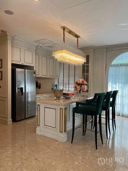Detached House for rent or sale in Thawi Watthana, Bangkok - Gourmet kitchen with island, pendant lighting and a tall arched window.