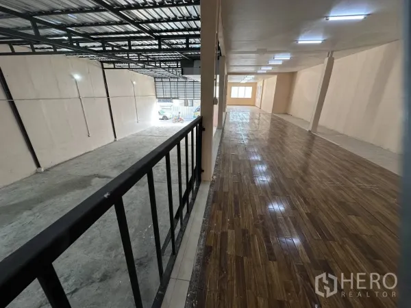Warehouse for rent in Din Daeng, Bangkok - Bright mezzanine walkway with wood-look flooring and LED lighting overlooking the warehouse floor.