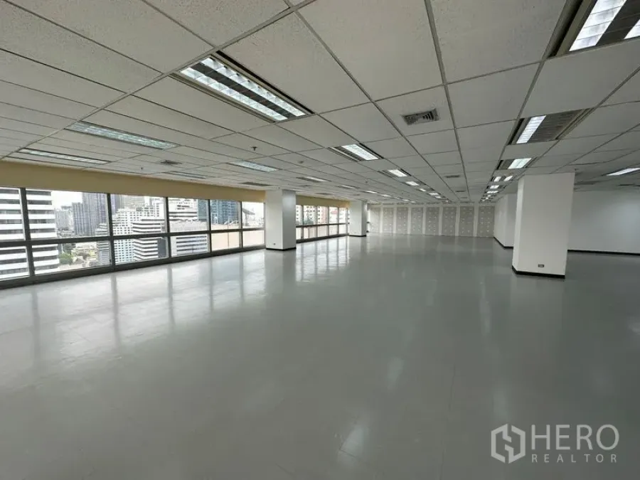 Office Space for rent - Long rectangular office floor with city views, tiled flooring and perimeter glazing.