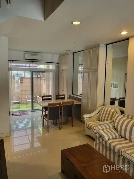 Townhouse for rent in Wang Thonglang, Bangkok - Open-plan living and dining area connecting to patio and small garden.