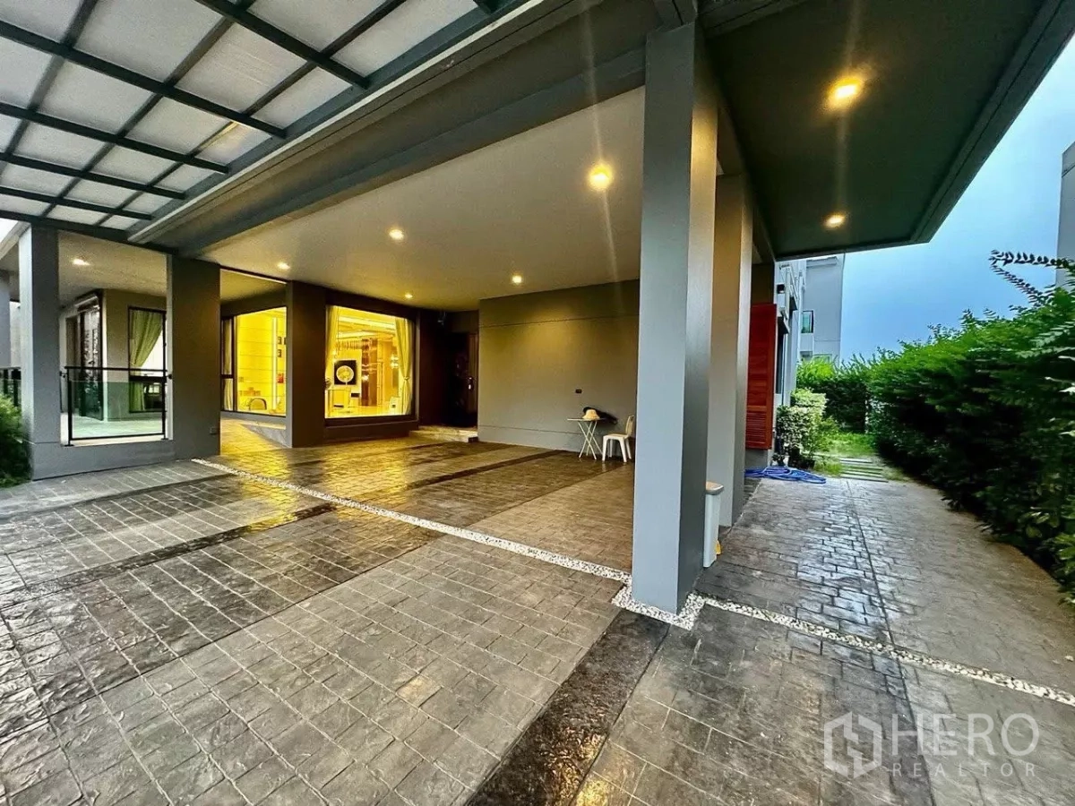 Detached House for sale in Saphan Sung, Bangkok - Spacious covered carport with tiled driveway, pillars and recessed ceiling lights.