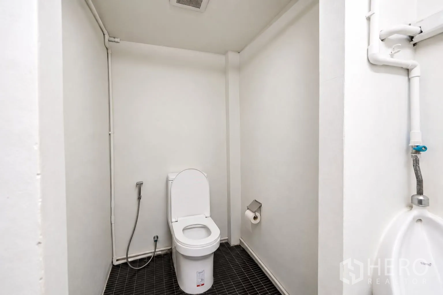 Retail Space for rent in Watthana, Bangkok - Toilet room with handheld bidet, tiled floor, and plumbing fixtures.