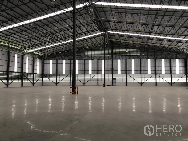 货栈 出租在Si Racha, Chon Buri - 高挑屋顶下的宽阔库区，设有垂直采光板与钢柱。