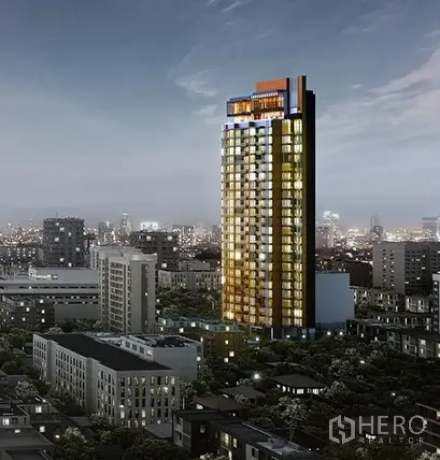 Condominium for sale in Watthana, Bangkok - Night view of a modern high‑rise condominium tower glowing above the Watthana, Bangkok skyline.