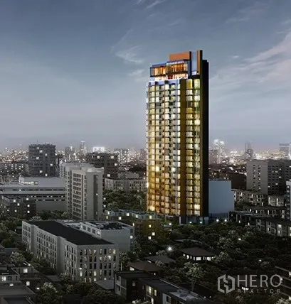 Condominium for sale in Watthana, Bangkok - Night view of a modern high‑rise condominium tower glowing above the Watthana, Bangkok skyline.