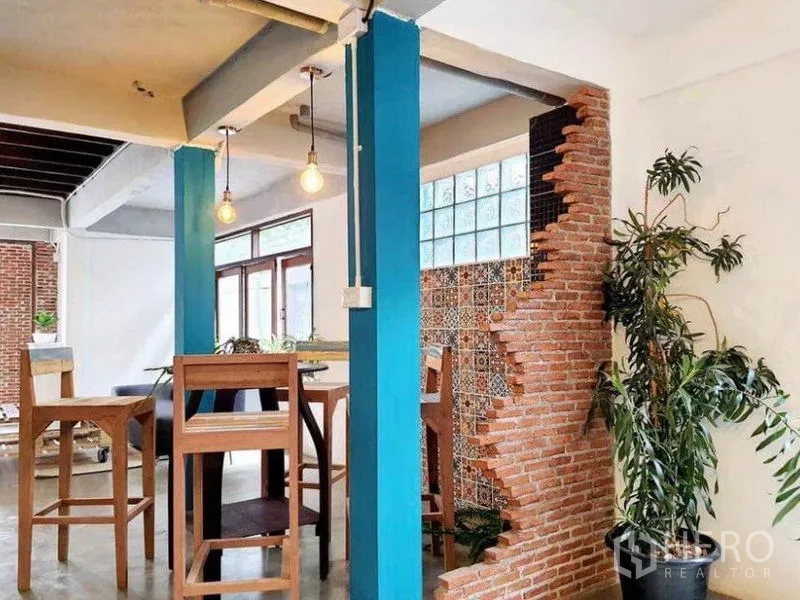 Detached House for rent in Pathum Wan, Bangkok - Casual bar seating beside blue columns and exposed brick with decorative tiles